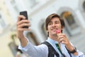 Selfie of handsome young man eating ice cream Royalty Free Stock Photo