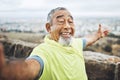 Selfie, happy and senior man hiking for health, wellness or cardio training on a mountain. Smile, nature and portrait of