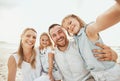 Selfie of happy woman, man and kids on beach, travel and happiness on ocean holiday in Australia together. Nature Royalty Free Stock Photo