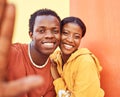 Selfie, love and memories with a black couple posing for a photograph together on a color wall background. Portrait