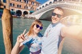Selfie lover couple taking photo travel Venice, Italy against backdrop great canal and bridge Royalty Free Stock Photo