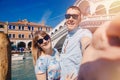 Selfie lover couple taking photo travel Venice, Italy against backdrop great canal and bridge Royalty Free Stock Photo