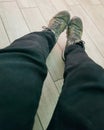 Selfie of a man's feet in a pair of green sneakers Royalty Free Stock Photo