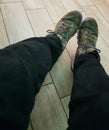 Selfie of a man's feet in a pair of green sneakers Royalty Free Stock Photo