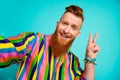 Selfie photo of young red hair well groomed man wear striped stylish shirt show v sign symbol peace isolated on blue Royalty Free Stock Photo