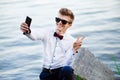 Selfie portrait man businessman student relaxing on beach sea showing v sign. handsome and young male model Royalty Free Stock Photo