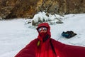 Selfie portrait of a man in a snowy Baikal in hummocks