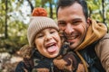 selfie portrait of photographer dad and his fashionable son with hat, very happy and excited doing a route Royalty Free Stock Photo