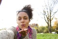 Selfie portrait of a young woman blowing a kiss