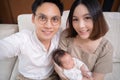 Selfie shot of lovely asian family with baby daughter. group shot of happy father, mother, infant. togetherness concept.