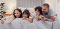 Selfie, smile and children with parents in bed relaxing and bonding together at family home. Happy, fun and young mother Royalty Free Stock Photo