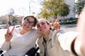 selfie of a smiling man and woman using wheelchair Royalty Free Stock Photo