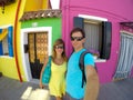 SELFIE: Smiling tourists pose in front of colorful buildings in sunny Venice.