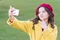 Selfie star. Small girl take selfie with smartphone outdoor. Little child V gesture to selfie camera in mobile phone Royalty Free Stock Photo