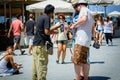 Selfie stick seller sells sticks to tourist at street of Chania town on Crete island