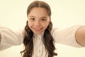 Selfie time. Child school uniform smart kid happy face. Girl cute long curly hair holds smartphone taking selfie white