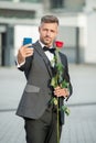 selfie time. man in tuxedo making selfie. man in bowtie outdoor. elegant man taking selfie.