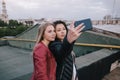 Selfie of two young girls on city background