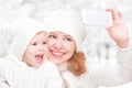 Selfie in winter. happy family mother with daughter and photogr Royalty Free Stock Photo