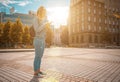 Selfie woman. Happy young girl with phone smile, typing texting and taking selfie in summer sunshine urban city. Pretty female Royalty Free Stock Photo