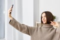 selfie woman photo smartphone mobile home blogger emotion phone camera trendy Royalty Free Stock Photo