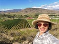 Selfie woman travel in vineyards, Okanagan valley, British Columbia Canada