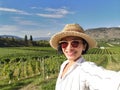 Selfie woman travel in vineyards, Okanagan valley, British Columbia Canada