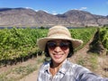 Selfie woman travel in vinyards, Okanagan valley, British Columbia Canada