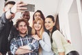 Selfie of young smiling teenagers having fun together. Best friends taking selfie outdoors with backlighting. Happy Royalty Free Stock Photo