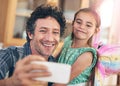 Selfies with my sweet little girl. a happy father and daughter taking a selfie together on a mobile phone at home. Royalty Free Stock Photo