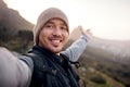 Selfies at the summit. Cropped portrait of a handsome young man taking selfies while hiking in the mountains. Royalty Free Stock Photo