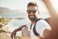 Selfies at the summit. Cropped portrait of a handsome young man taking selfies while hiking in the mountains. Royalty Free Stock Photo