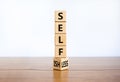 Selfish or selfless symbol. Turned cubes and changed the word `selfish` to `selfless`. Beautiful white background, copy space.