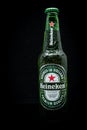 Selinsgrove, Pennsylvania - March 18, 2019: A bottle of Heineken beer isolated against a black background.