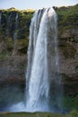 Seljalandsfoss gorge, in Iceland. Incidental people behind the water