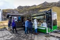 Seljalandsfoss, Iceland - Oct 22th 2017 - Young buying food in a kind of food truck trailer in Seljalandsfoss fall in a overcast d
