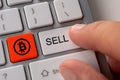 Sell bitcoin concept. Close up keyboard button choice of selling cryptocurrency bitcoin to get profit Royalty Free Stock Photo