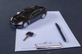Sell, buy, rent, search for cars. Clipboard, key, pen and black car