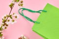 Sell concept. green shopping bag on a pink background. decorating with spring flowers Royalty Free Stock Photo