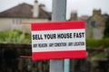 Sell your house fast sign outside residential area during property crisis Royalty Free Stock Photo