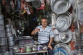 Seller aluminum dishes and pots in kitchenware shop, Shiraz, Ira