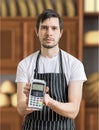 Seller in bakery is passing payment terminal for paying with credit card Royalty Free Stock Photo