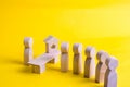 The seller is behind the counter and serves customers. A queue of customers is standing in line and waiting for their turn to serv Royalty Free Stock Photo