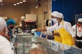 the seller in the butcher shop disinfects the counters and the buyer chooses the meat