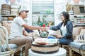 Seller and buyer agree by shaking hands while using tablet, laptop and electronic data capture machines Royalty Free Stock Photo