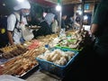 Seller and buyer nasi kucing or angkringan, junk food, gorengan, small size night street food at yogyakarta