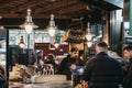 Seller and customers at charcuterie and cheese stand in Borough Market, London, UK