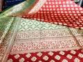 A seller displaying Indian sari in a clothing store