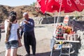 The seller - druz stands with the customer and offers the goods, near his shop with canned sweets in the parking lot, on Mount Ben Royalty Free Stock Photo