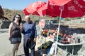 The seller - druz stands with the customer and offers the goods, near his shop with canned sweets in the parking lot, on Mount Ben Royalty Free Stock Photo